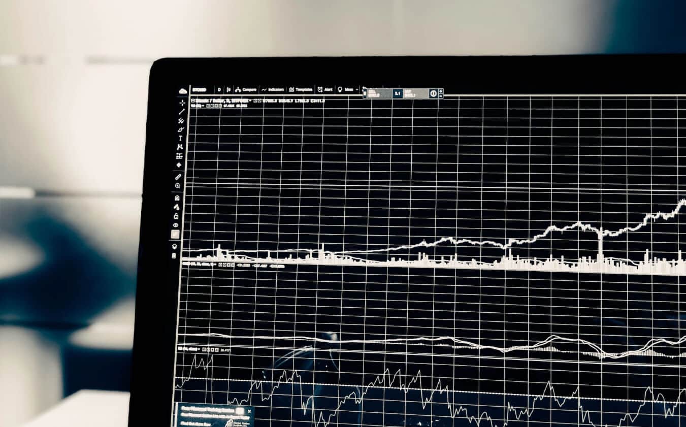 image of laptop with a black and white trading chart