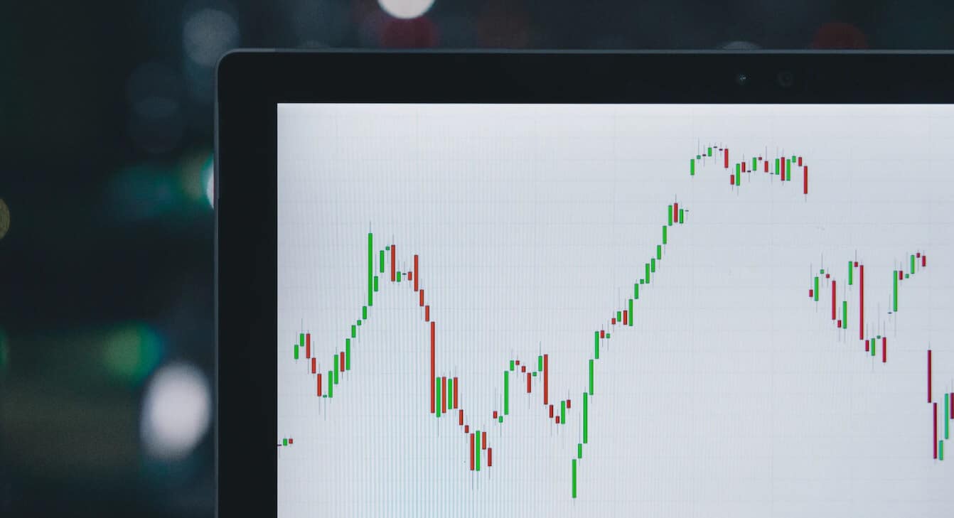 laptop showing green and red forex chart
