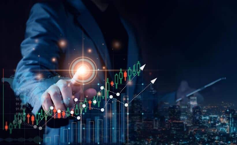 man in suit pointing and touching virtual trading chart