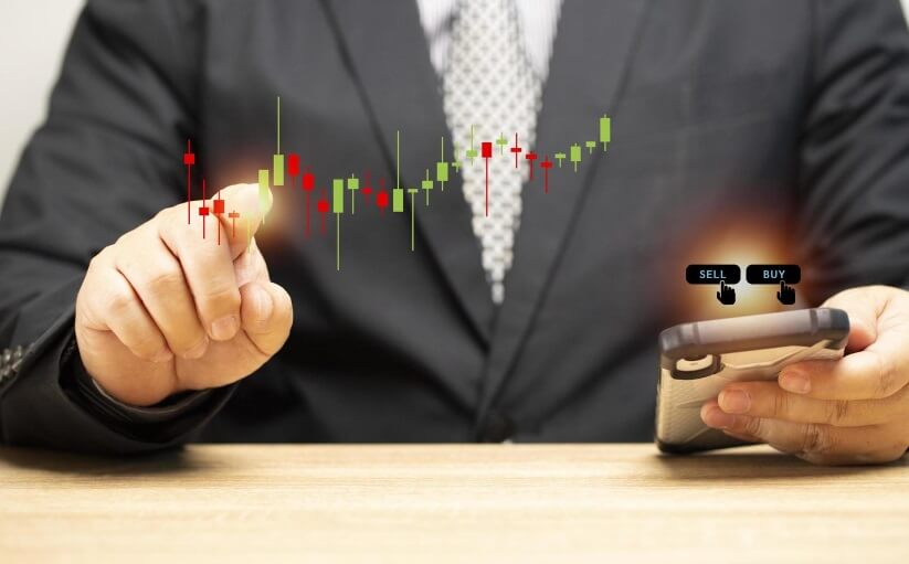 man touching holographic price action and holding phone