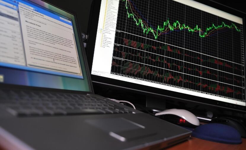 laptop and screen showing forex chart