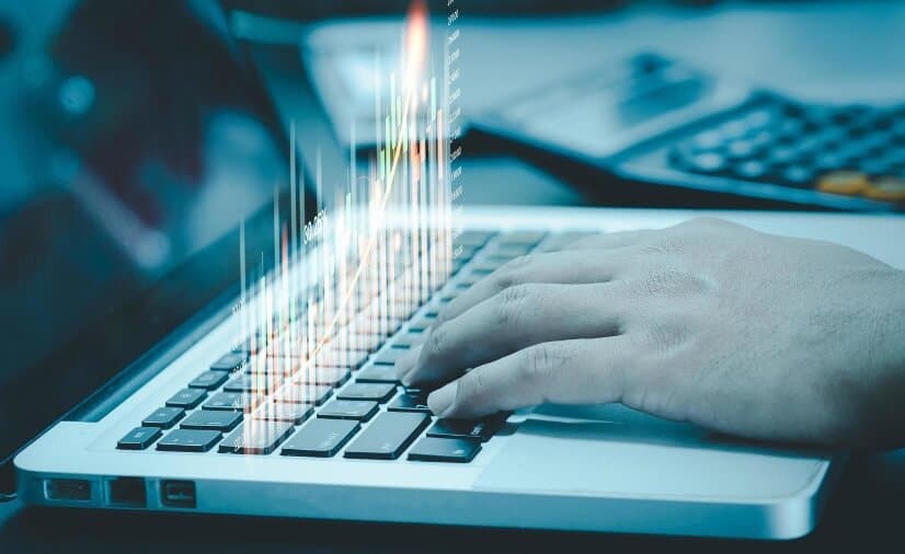 holographic trading chart on laptop keyboard