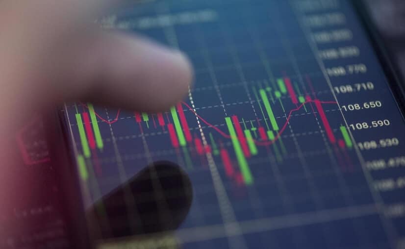finger touching phone screen showing price action