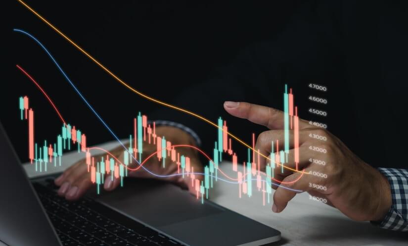 finger hovering over desk touching virtual trading chart