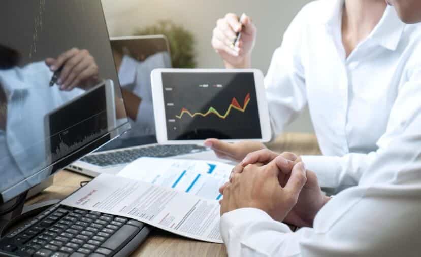 person showing trading chart to someone