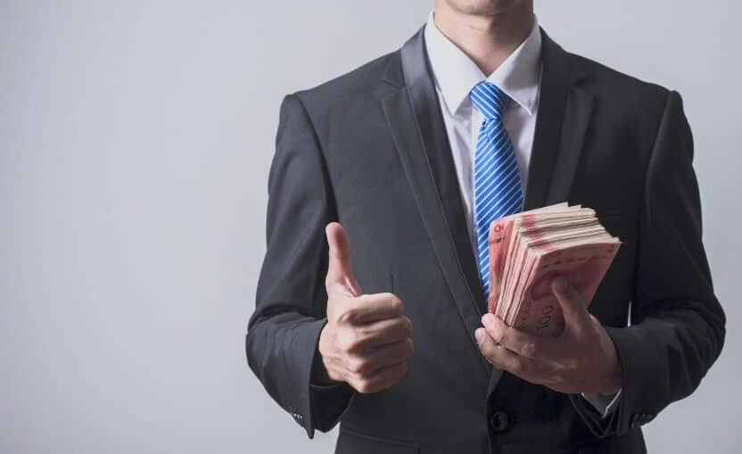 man holding a lot of USD bills