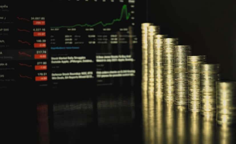 coins in front of forex chart