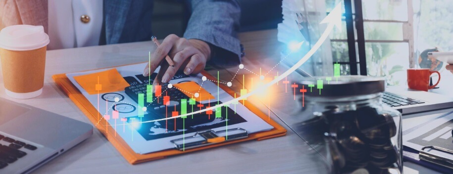 data board behind trading lines going up with man