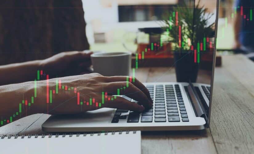 laptop with virtual forex chart overlay