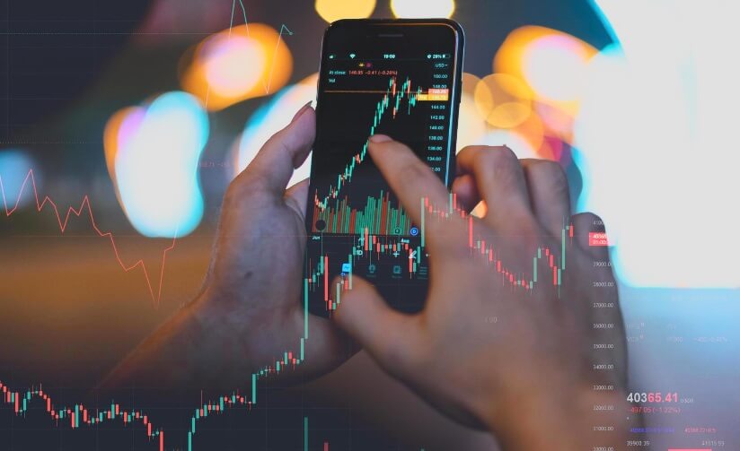 hands holding phone showing forex chart