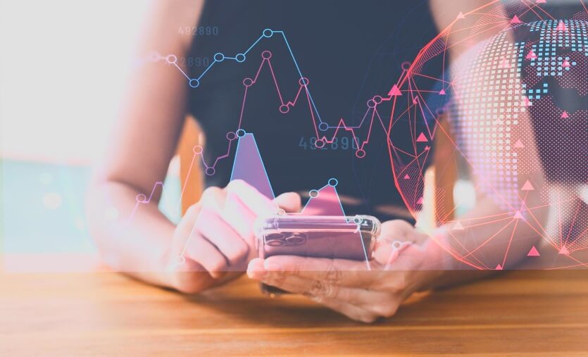 woman with phone showing virtual trading data pink