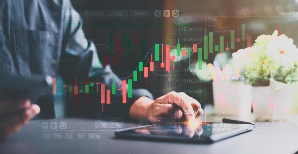 virtual forex chart with tablet behind on table