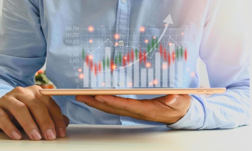 hand holding tablet showing forex chart