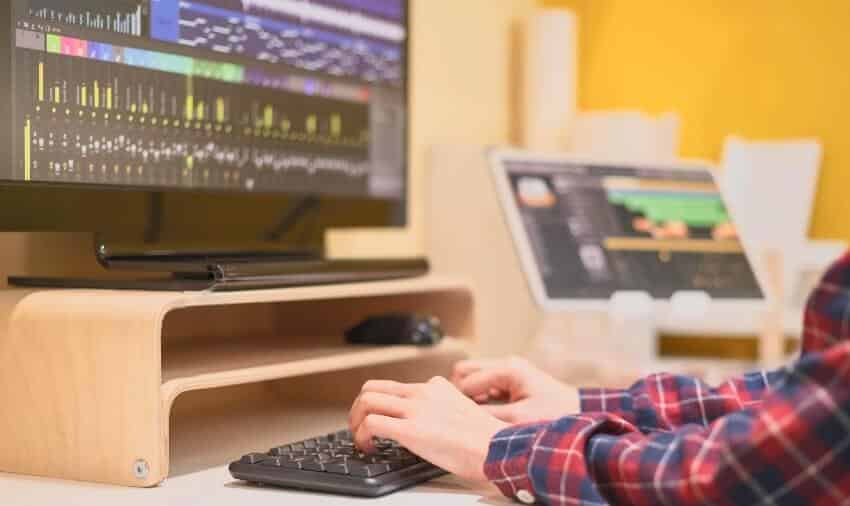man sitting behind desk showing forex trading chart